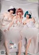 A group of three women in wedding dresses posing for a magazine.