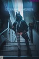 A woman in a black outfit is sitting on some stairs.