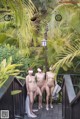 A group of naked women standing next to each other on a balcony.