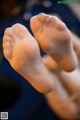 A close up of a person's bare feet on a table.