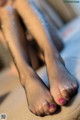 A close up of a woman's legs in fishnet stockings.